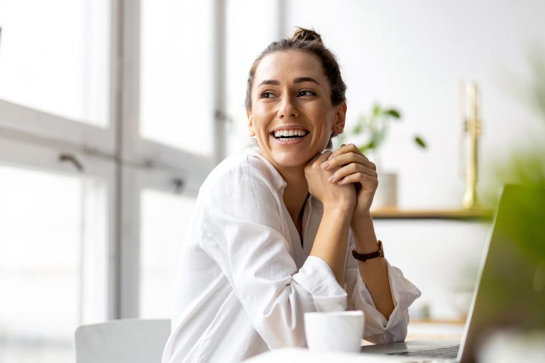 Woman on laptop smiling